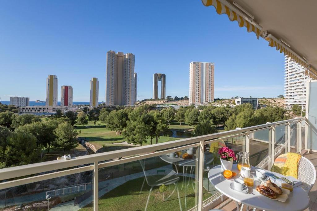 a balcony with a table and a view of a city at Ona Benidorm Poniente in Benidorm