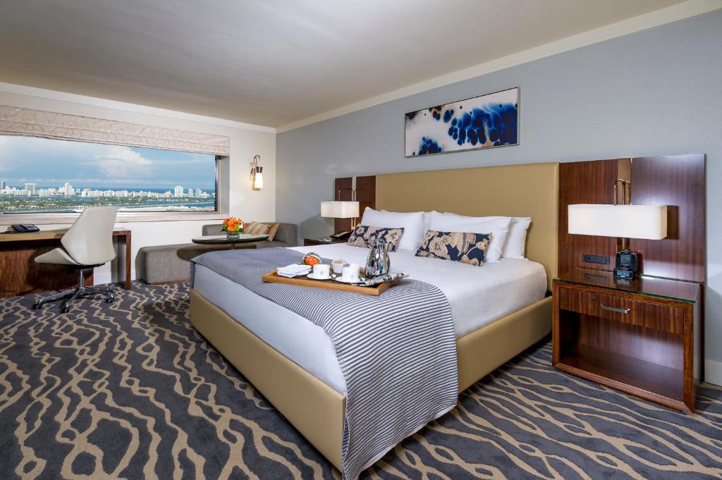 a hotel room with a large bed and a desk at InterContinental Miami, an IHG Hotel in Miami