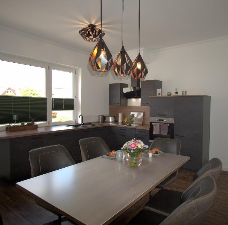 a kitchen with a table and chairs in a kitchen at Ferienwohnung Busch in Bad Sachsa