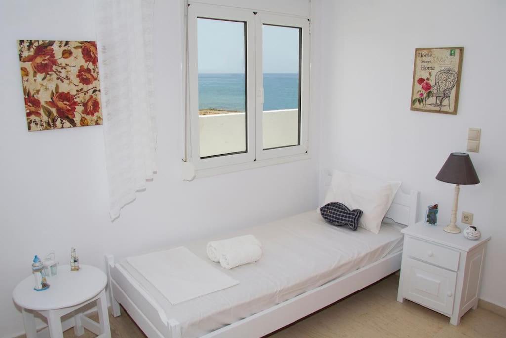 A bed or beds in a room at white house by the sea