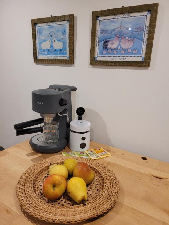 a basket of fruit on a table with a mixer at Haus Evelynchen Apartment 1 Deutschhof 