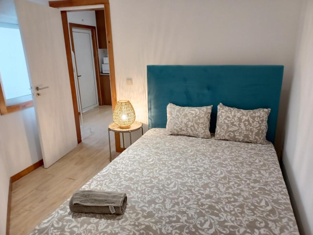 a bedroom with a large bed with a blue headboard at Enjoy Oporto Campanha 3 in Porto