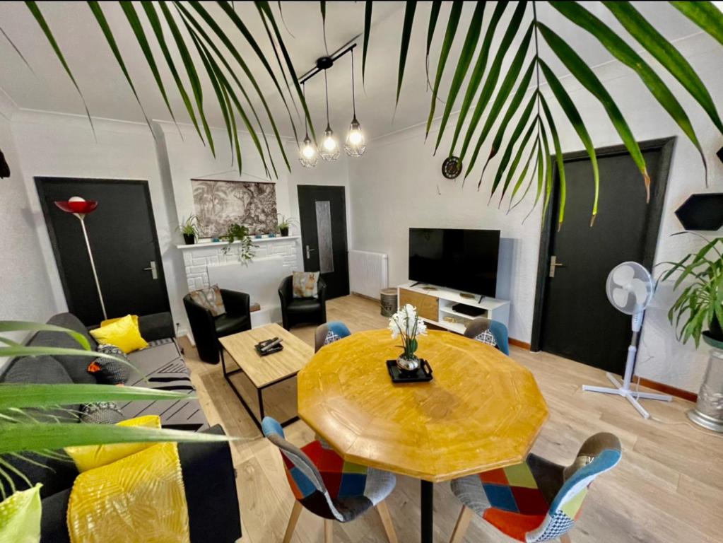 uma sala de estar com uma mesa e um sofá em Très grand appartement à 10 min à pied du centre em Castres