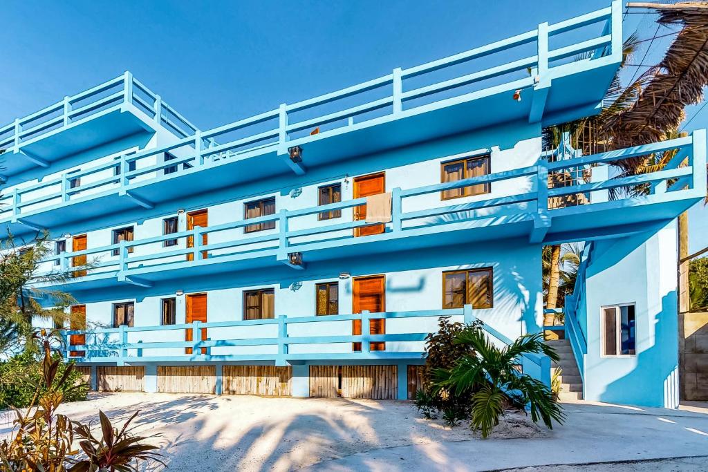 a blue and white building with a balcony at Mayan Falls Gold Standard and Corridor Certified in Caye Caulker