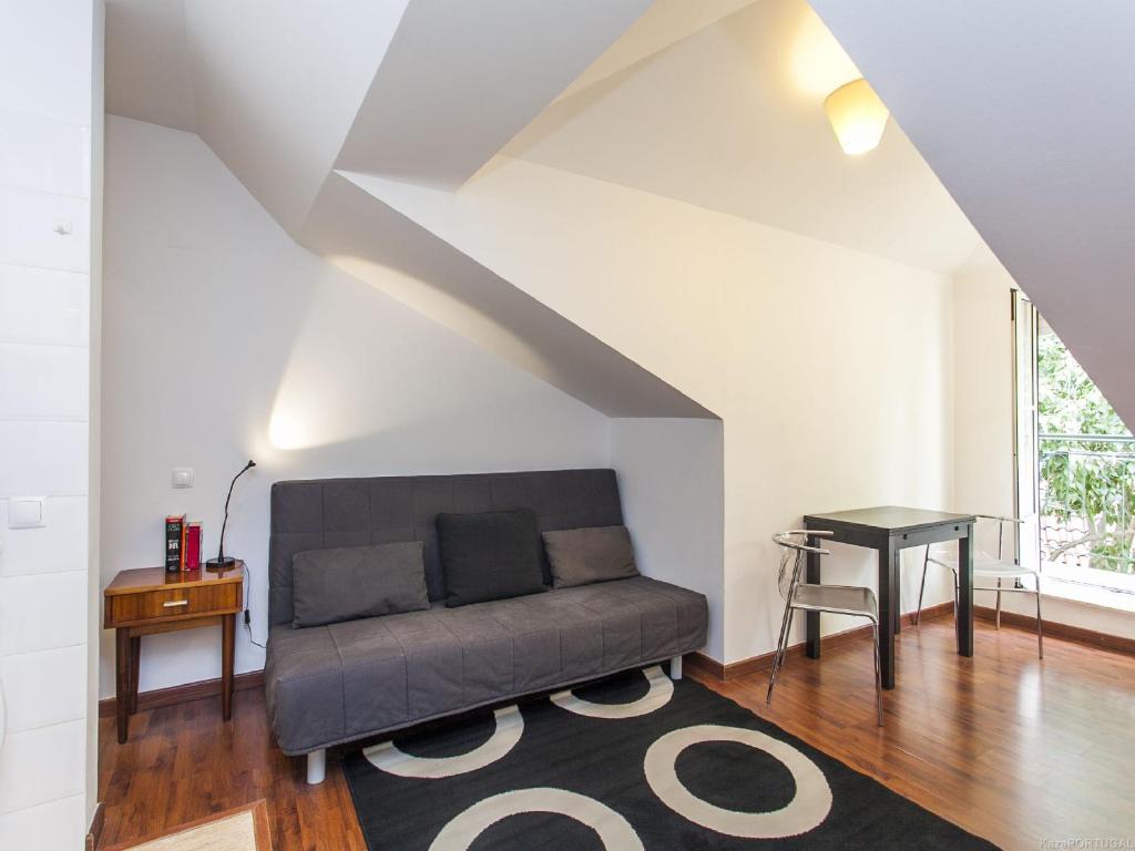 a living room with a couch and a table at Convento Apartment Rossio in Lisbon
