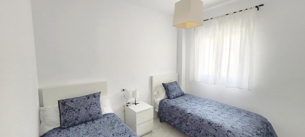 Postel nebo postele na pokoji v ubytování Casa Playa de Valdelagrana