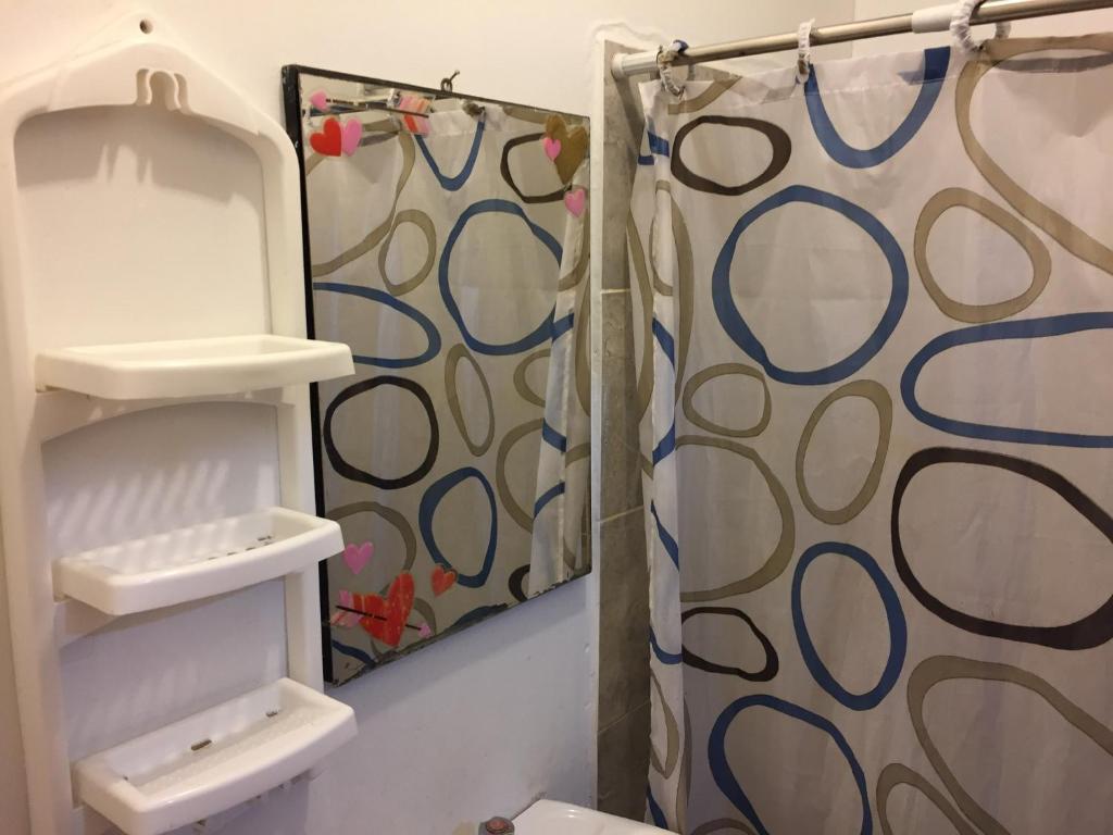 a bathroom with a shower curtain and a sink at Hospedaje Casa Amazónica Iquitos in Iquitos