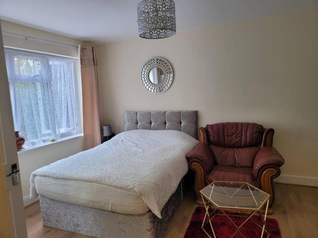 a bedroom with a bed and a chair at Lovely Studio in Town Centre in Reading