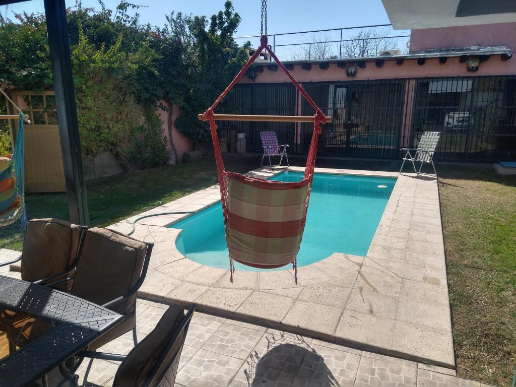a hammock is hanging over a swimming pool at EDU'S HOUSE i in Guaymallen