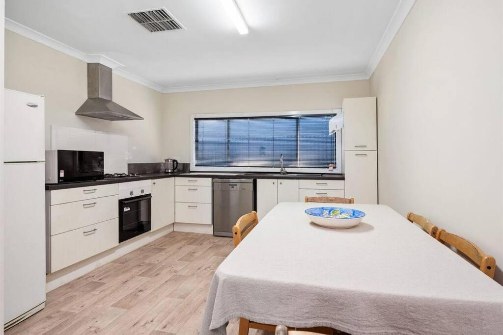 a kitchen with a table with a bowl on it at 4-Bedroome home, new bathrooms and close to town in Kalgoorlie