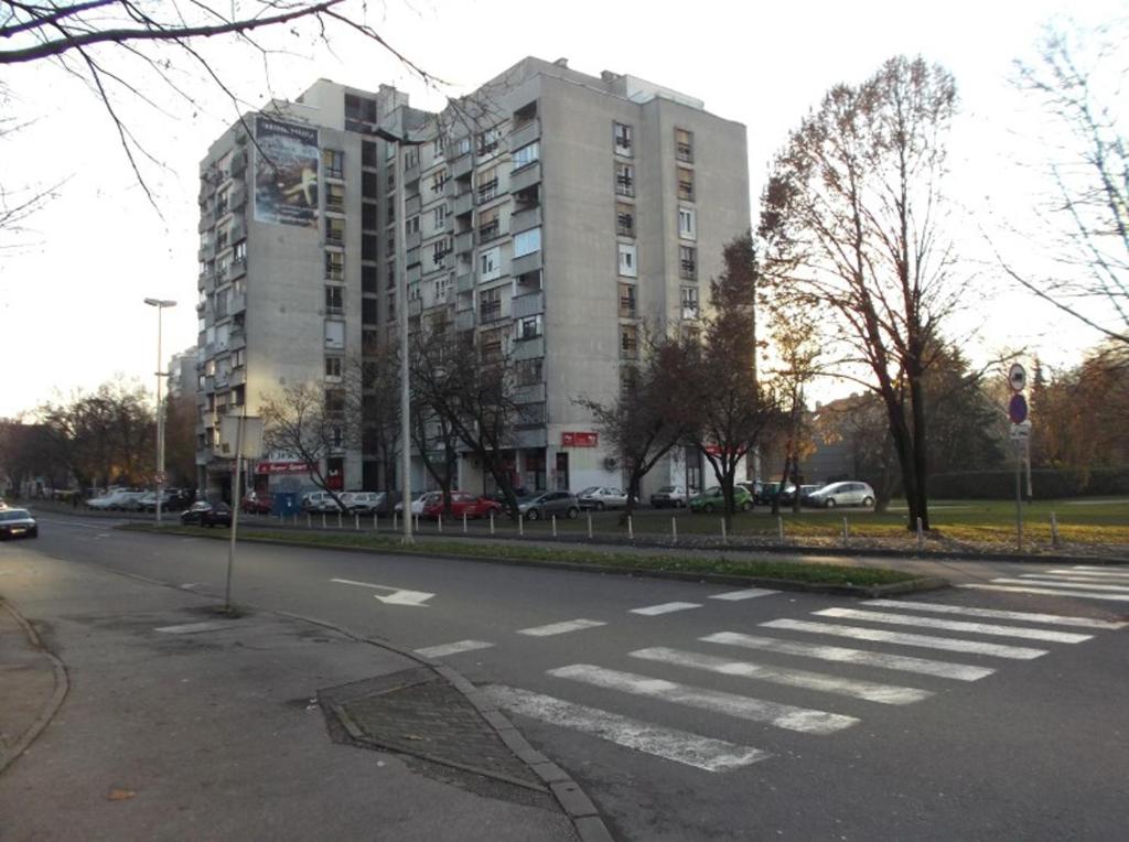 an empty street with a large building in the background at Apartments with WiFi Zagreb - 15314 in Zagreb