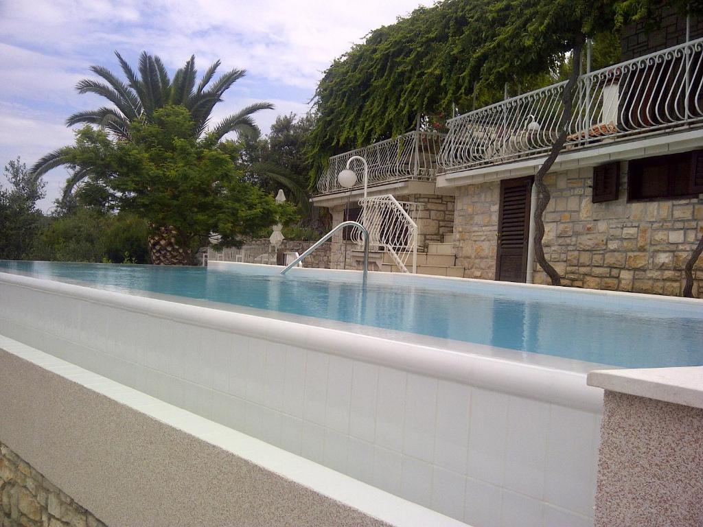 a swimming pool in front of a building at Seaside house with a swimming pool Cove Pribinja, Hvar - 15324 in Hvar