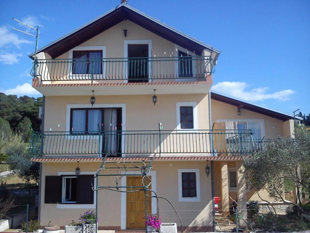 a large house with a balcony on top of it at Apartments with WiFi Zlarin - 15409 in Zlarin