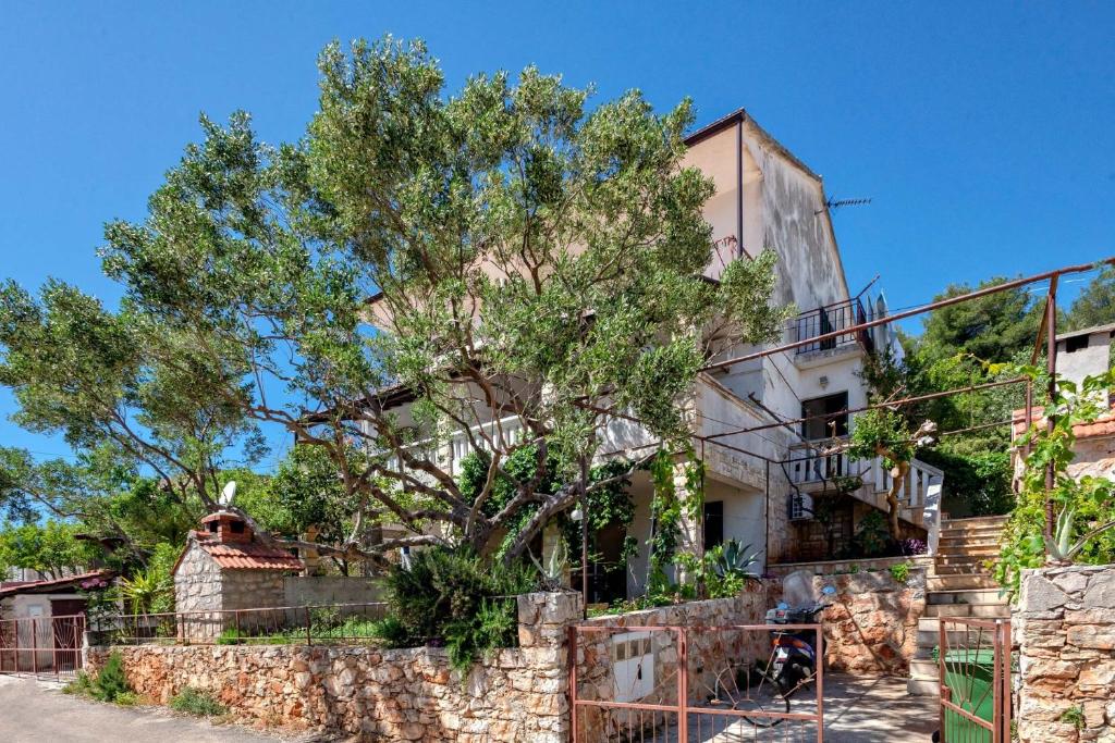 an old house with a tree in front of it at Apartments with WiFi Stari Grad, Hvar - 15464 in Stari Grad