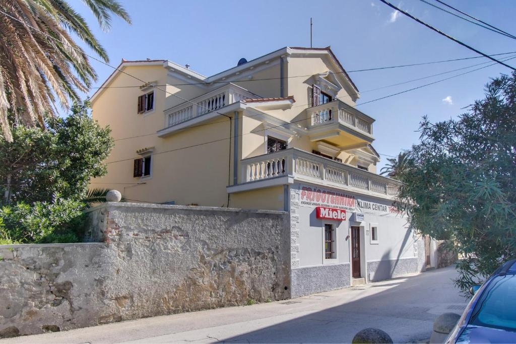 a building on the side of a street at Apartments by the sea Mali Losinj (Losinj) - 15576 in Mali Lošinj