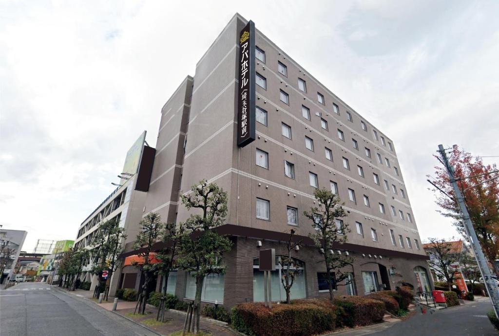 een gebouw met een bord aan de zijkant bij APA Hotel Saitama Yatsuka Ekimae in Soka