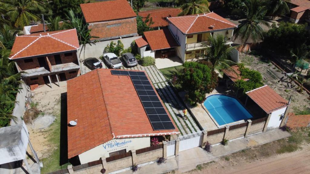 an aerial view of a house with solar panels on the roof at Pousada Villa Manduca in Amontada