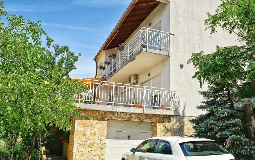 a white car parked in front of a house at Apartments with a parking space Smrika, Kraljevica - 15709 in Šmrika