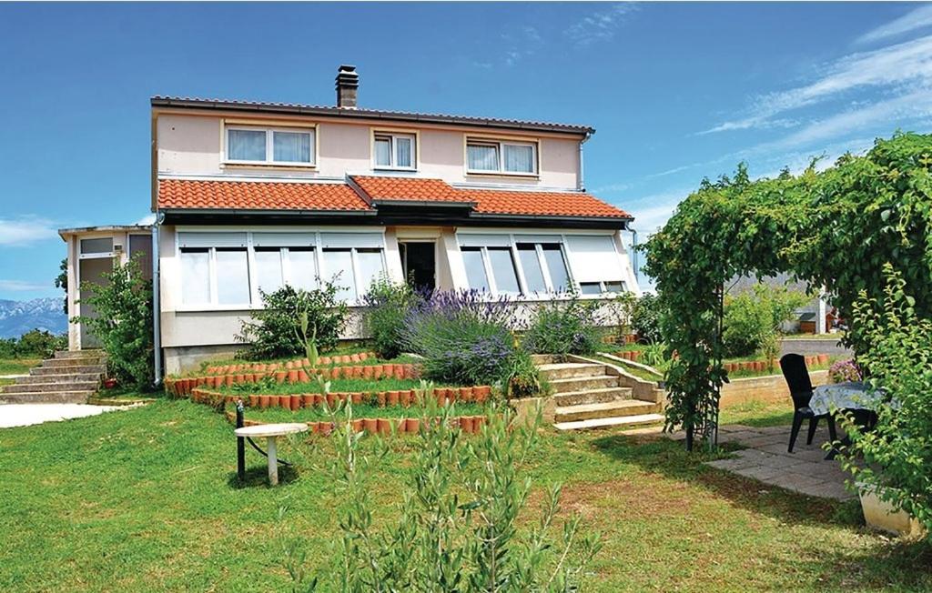 a house with a garden in front of it at Family friendly house with a swimming pool Posedarje, Novigrad - 15785 in Islam Latinski