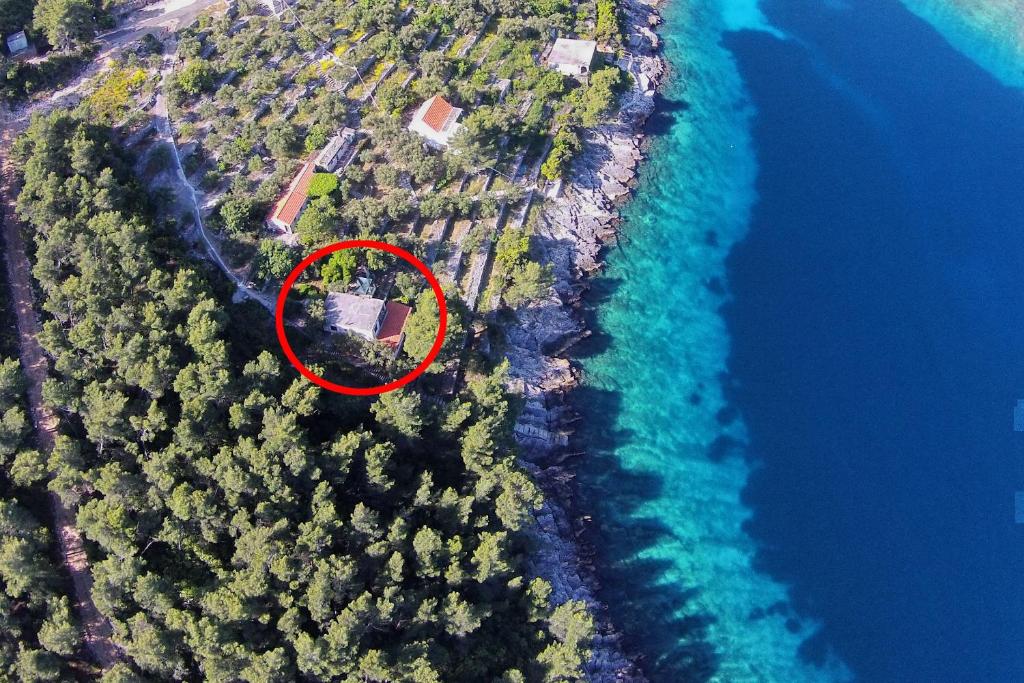 an island with a house in the middle of the water at Apartments by the sea Crnja Luka, Korcula - 15978 in Blato