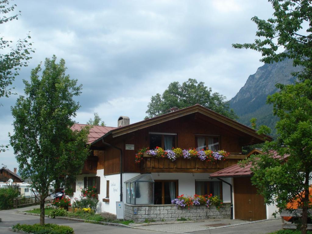 una casa con un balcón con flores. en Landhaus Alpensee 2, en Oberstdorf