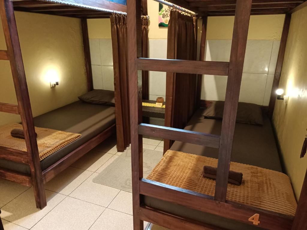 a room with three bunk beds in a hostel at Chacha Homestay & Dormitory in Ruteng