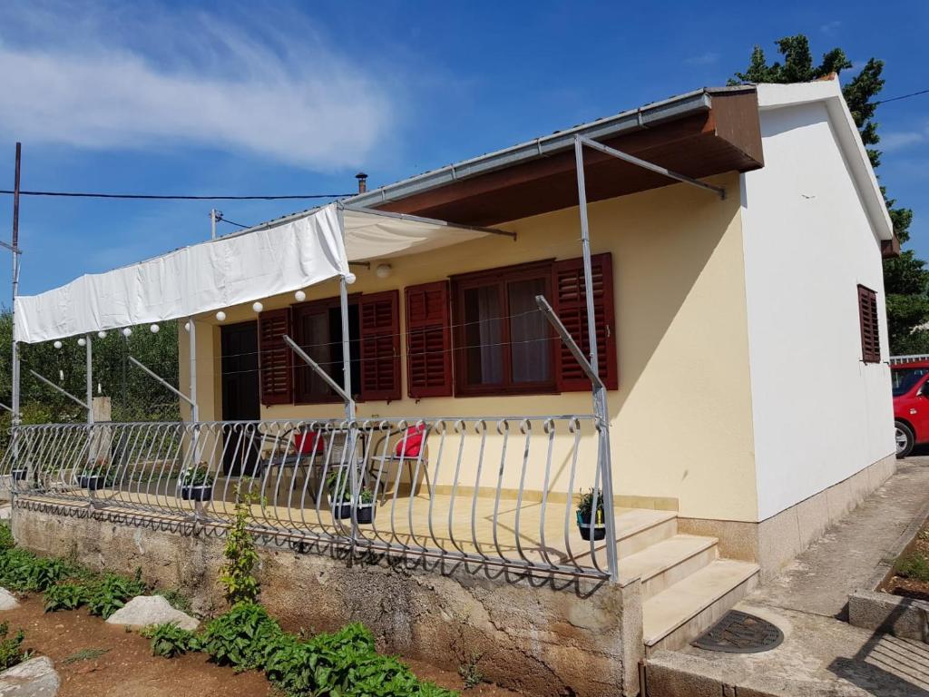 a white house with a fence in front of it at Apartments with parking space Kastel Stafilic, Kastela - 16086 in Kaštela