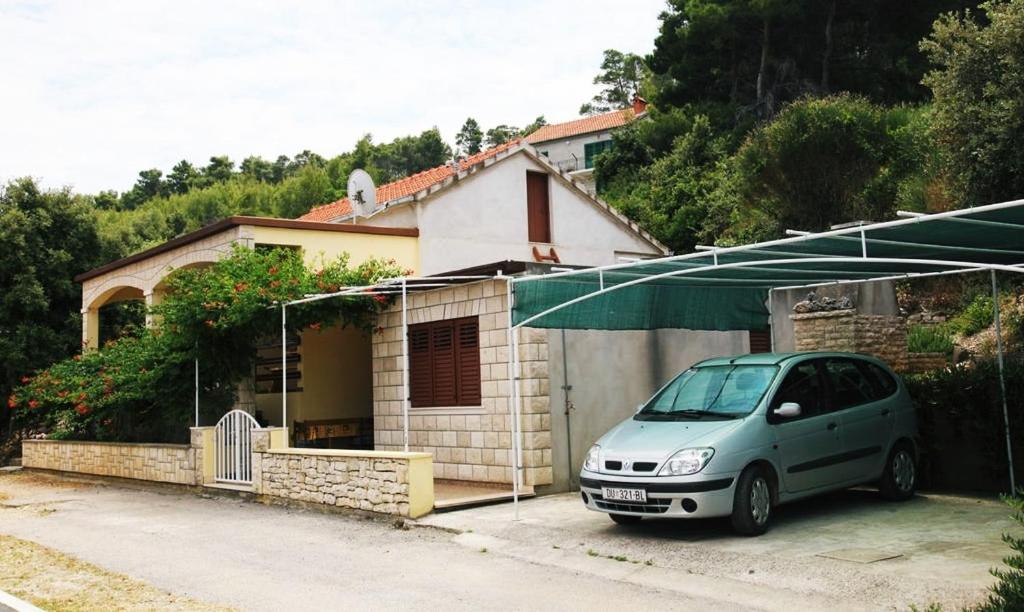 a small van parked in front of a house at Apartments by the sea Prigradica, Korcula - 16125 in Blato
