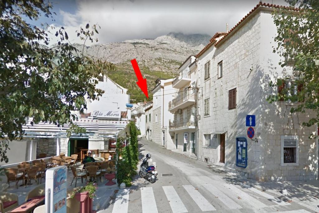 a red arrow pointing down a street in a town at Seaside holiday house Baska Voda, Makarska - 16138 in Baška Voda