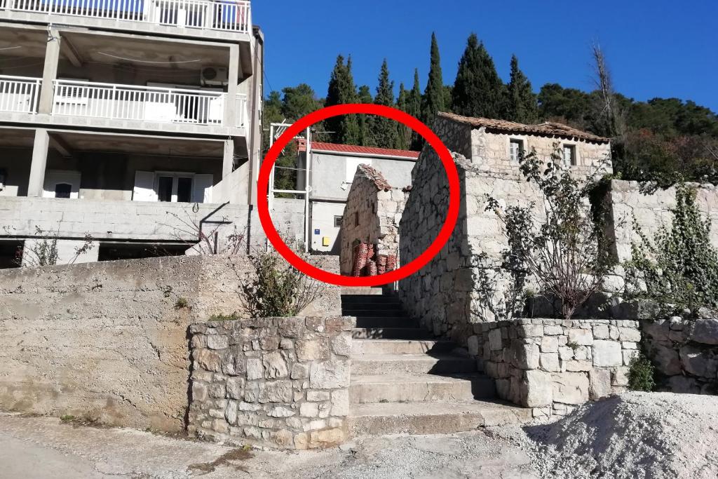 a person is standing on some stairs in a red circle at Apartments with a parking space Luka, Peljesac - 16229 in Ston