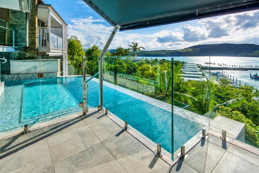 a view from the balcony of a house with a swimming pool at Habitat on Hamilton Island by HIHA in Hamilton Island