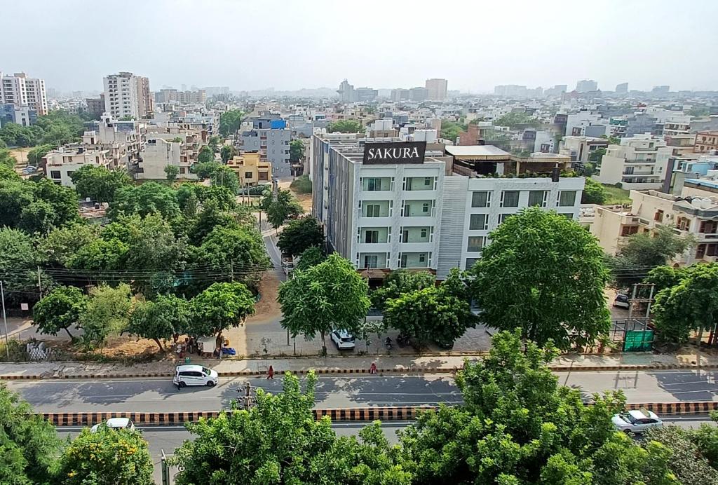 a view of a city with a building at Hotel Sakura by Maps in Gurgaon
