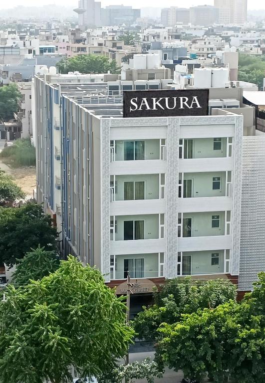 a building with a sign on top of it at Hotel Sakura by Maps in Gurgaon