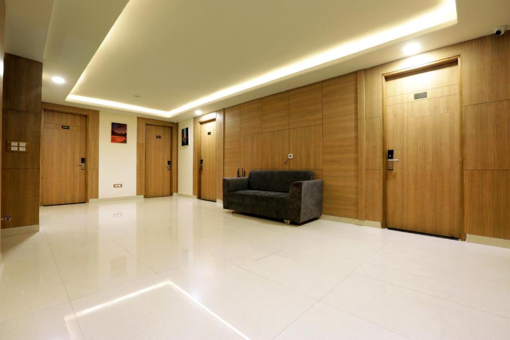 a waiting room with a couch in the middle at Hotel Sakura by Maps in Gurgaon
