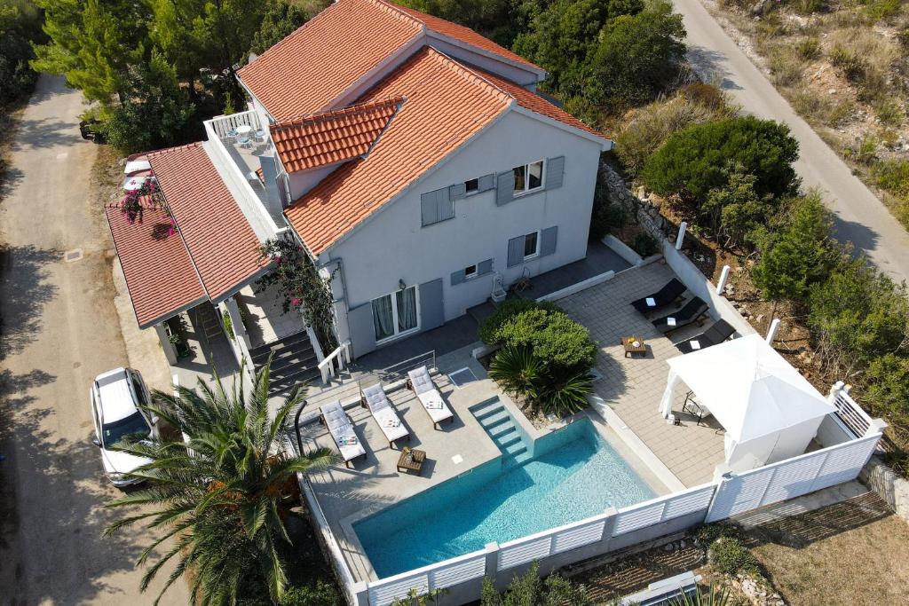 an aerial view of a house with a swimming pool at Seaside house with a swimming pool Pasadur, Lastovo - 15847 in Lastovo