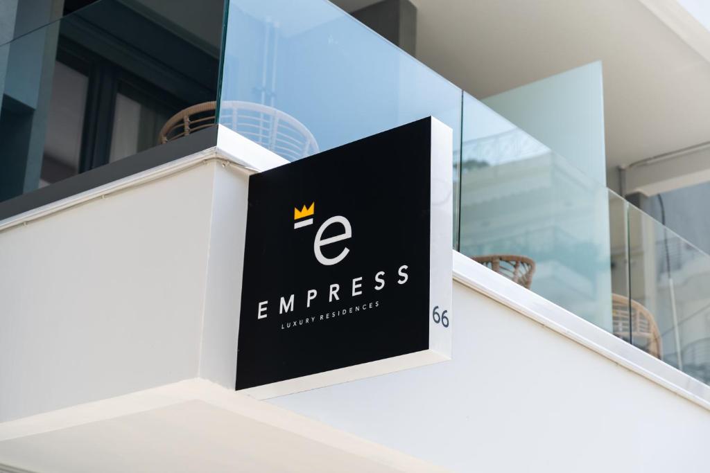 a sign on the side of a building at Empress Luxury Residences in Volos