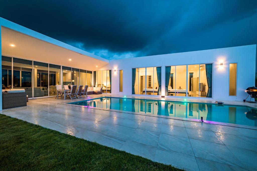 a villa with a swimming pool at night at Modern 4 Bedroom Pool Villa KH-A6 in Khao Tao