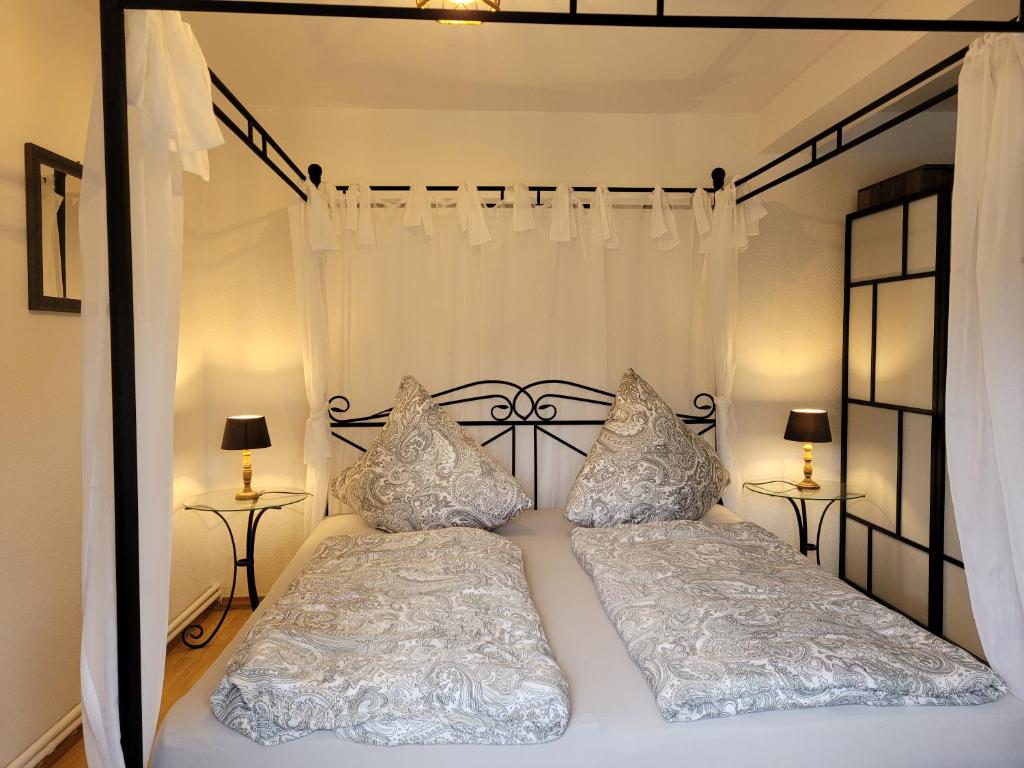 a bedroom with a white bed with two pillows at Neues Schwalbennest 26 Haus in Büsum