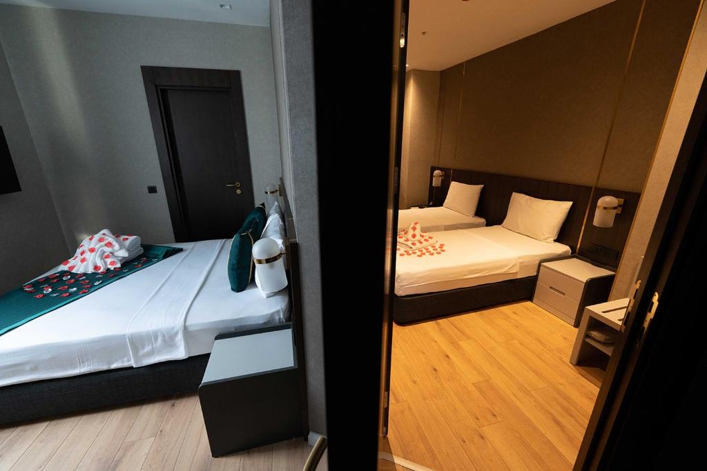 Postel nebo postele na pokoji v ubytování Costera Hotel
