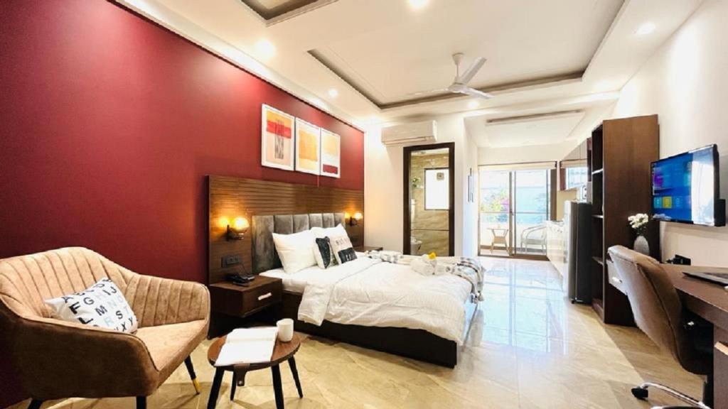 a bedroom with a bed and a desk and a tv at ZEN Studios - DLF CyberCity Gurgaon in Gurgaon