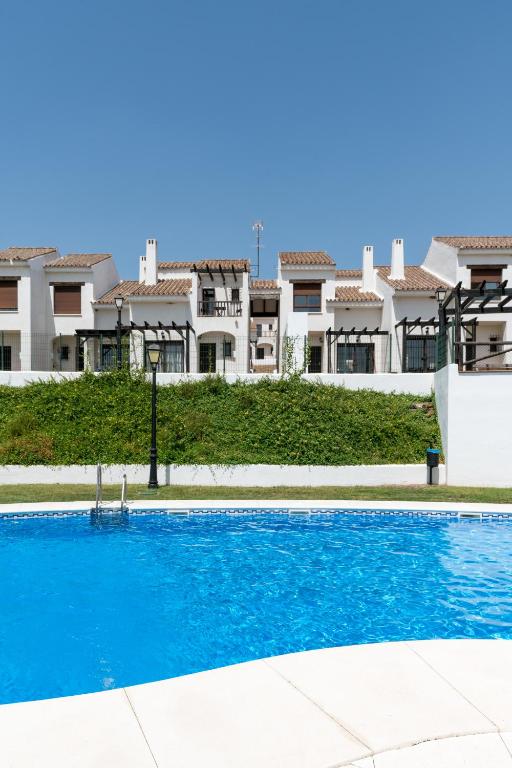 a swimming pool in front of a building at Casa Rural Sierramagna de 2 Dormitorios in El Ronquillo