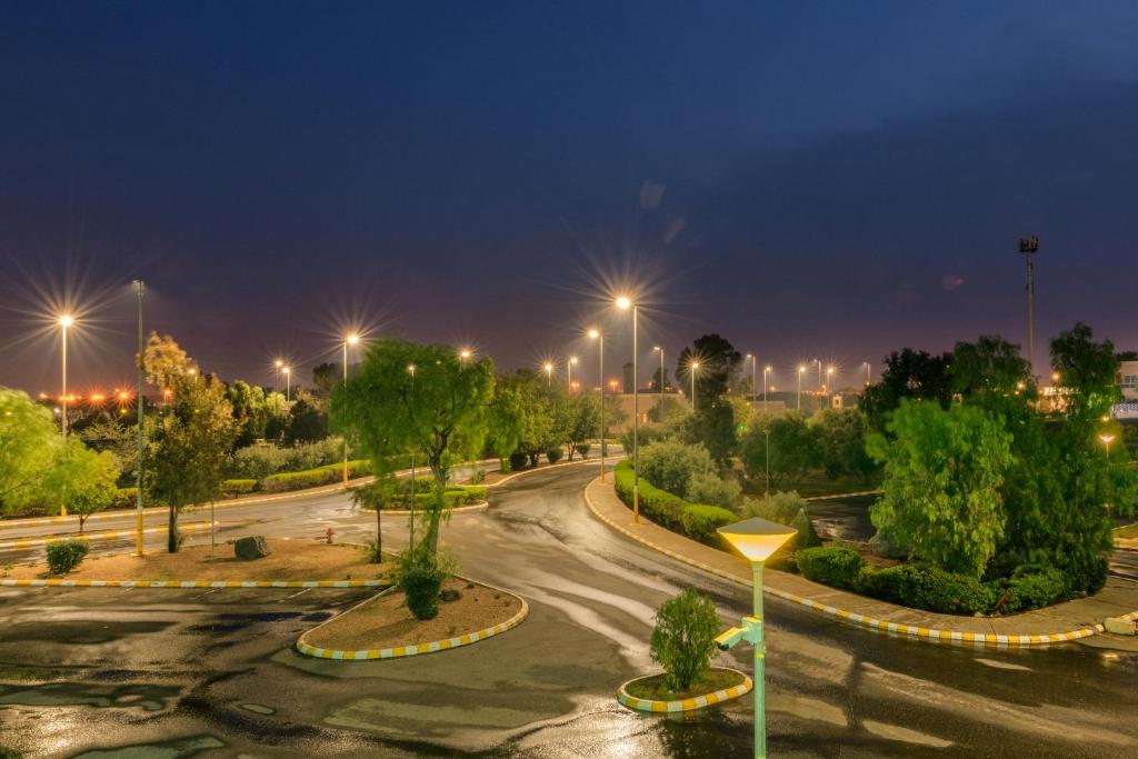 an empty street at night with street lights at Airport Hotel in Abha