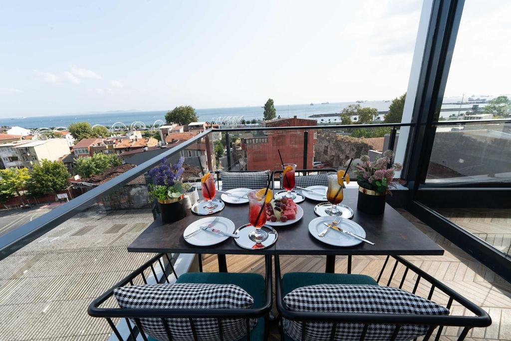 a table with plates of food on a balcony at Costera Hotel in Istanbul