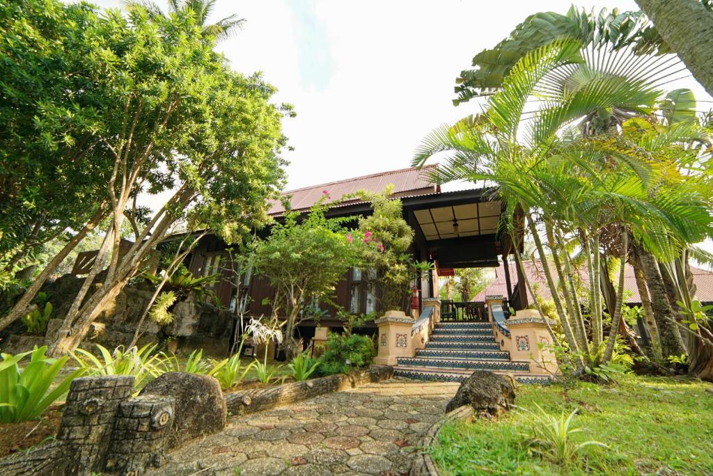 a house with a staircase leading up to it at LaVilla By Holiday Villa Cherating in Cherating