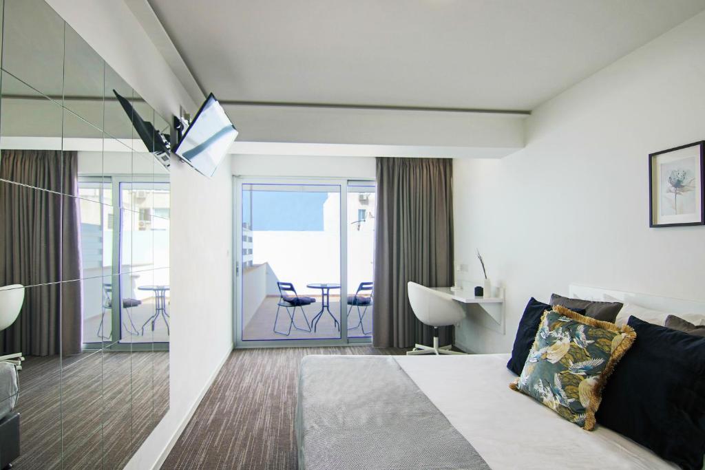 a bedroom with a bed and a view of a balcony at Phaedrus Living: Luxury Suite Nicosia 502 in Nicosia