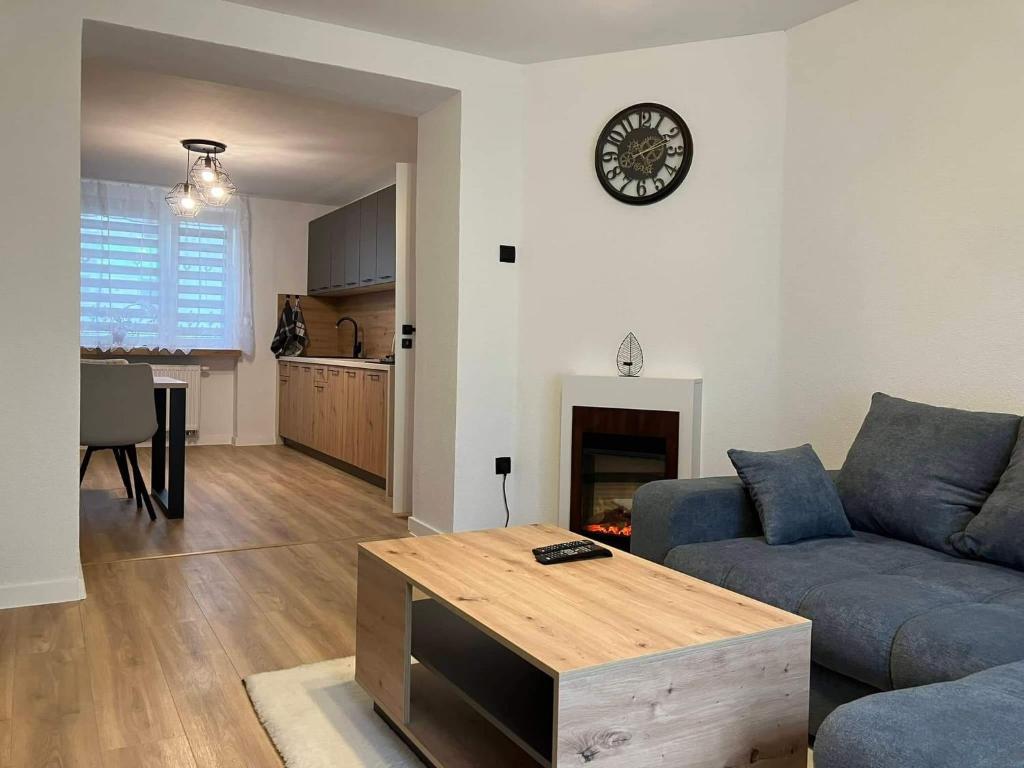 a living room with a couch and a table at Apartmán Nelka v Poprade in Poprad