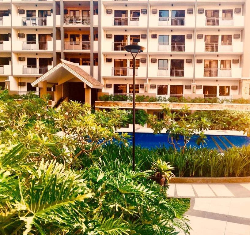 a large apartment building with a pool in front of it at condo-living at its best in Manila