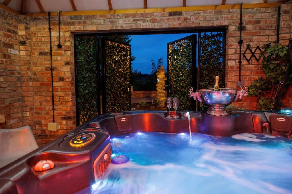 a jacuzzi tub in a backyard with aperature at Lincoln Holiday Retreat View with Private Hot Tub in Lincoln