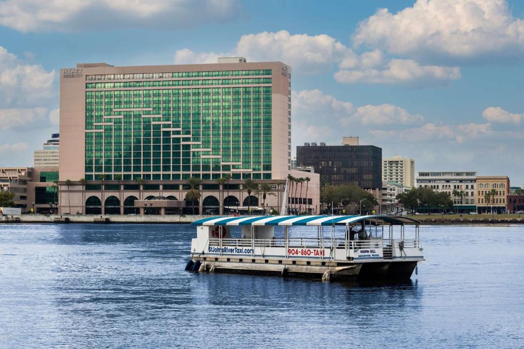 a boat on the water in front of a building at Hyatt Regency Jacksonville Riverfront in Jacksonville