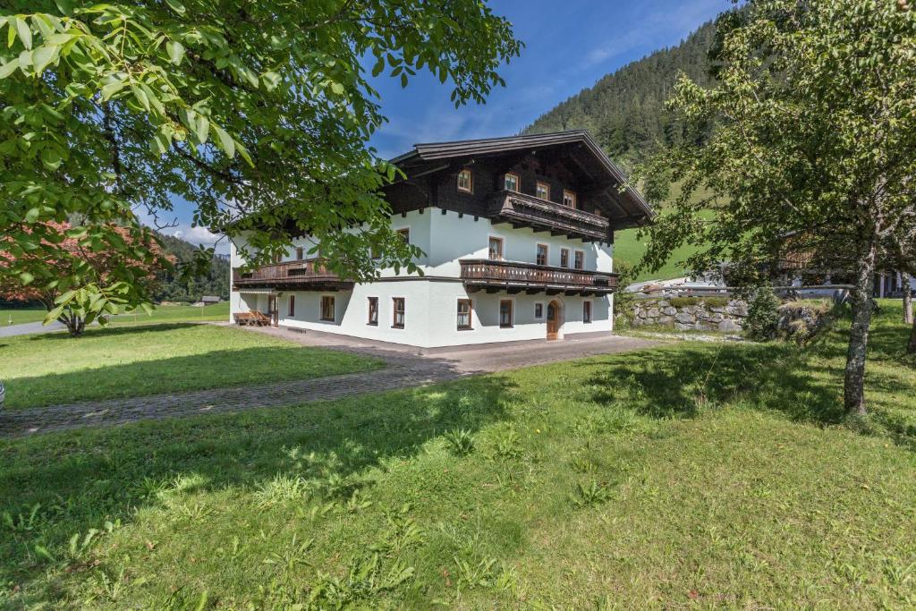 a house in the middle of a grassy field at Ferienwohnung Jägermeister in Sankt Martin bei Lofer